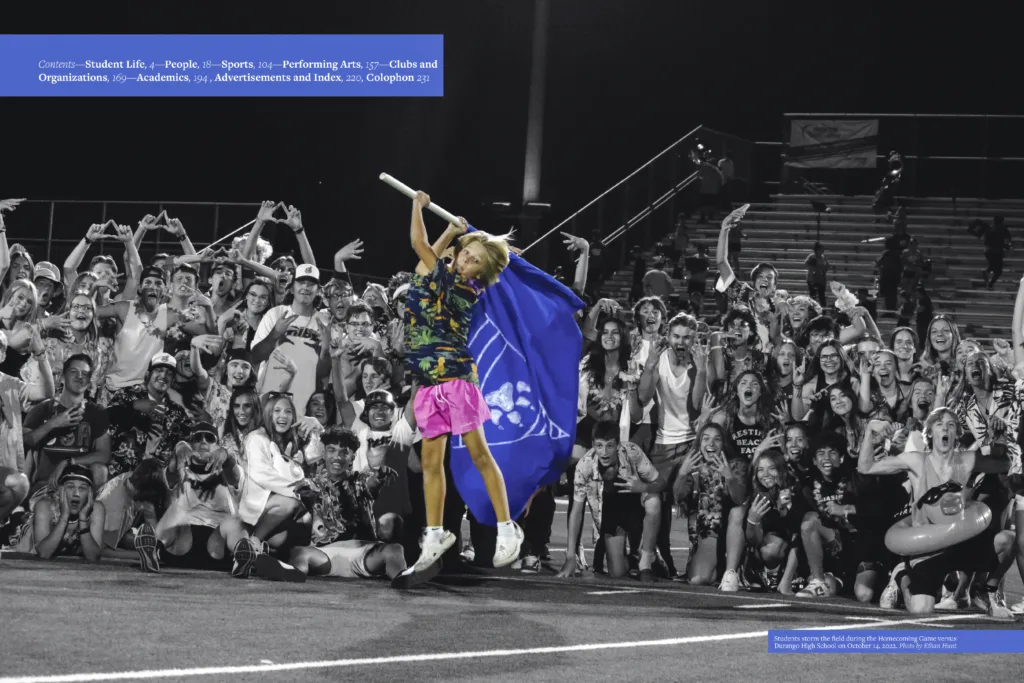 Yearbook spread featuring students in the "Blue Zone" student section wearing school colors, cheering at a football game, and waving flags.