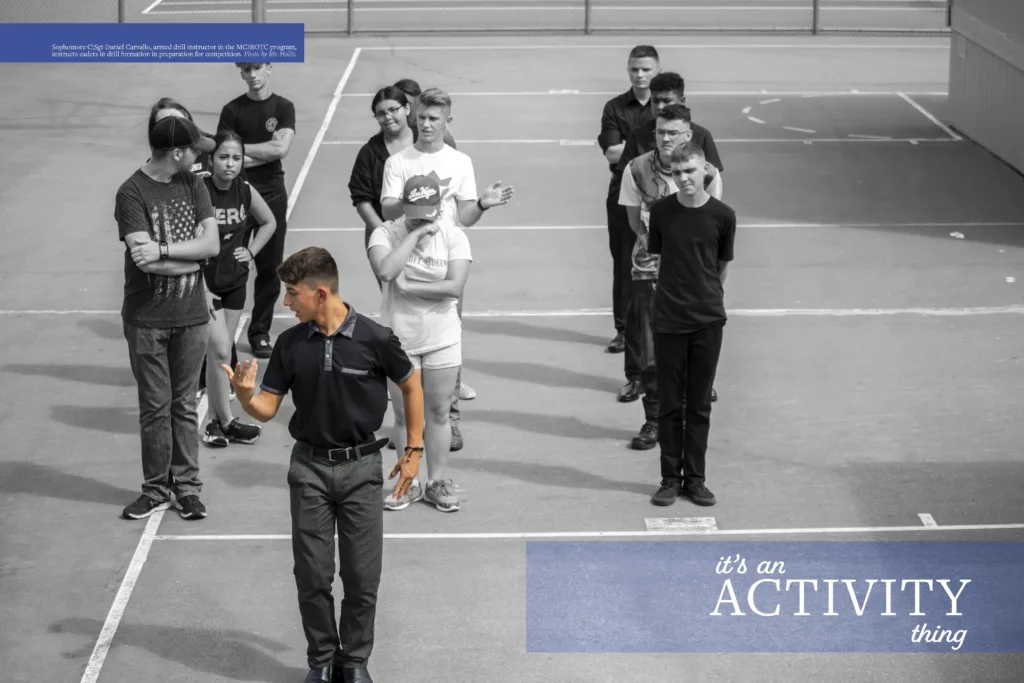 Yearbook spread titled "it's an ACTIVITY thing" from the 2023 El Lobo yearbook, featuring a black and white photo of MCJROTC cadets in drill formation being instructed by a student in a black polo shirt.