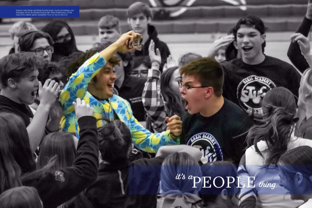 A yearbook spread from the 2023 El Lobo yearbook titled "it's a PEOPLE thing," featuring a large central photo of students in the "Blue Zone" cheering at an assembly. One student in a blue and yellow Hawaiian shirt is particularly expressive.
